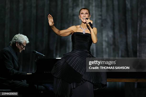 Canadian singer Celine Dion gestures as she performs during her first concert of a series at the Plenitude Arena in Nanterre, west of Paris on...