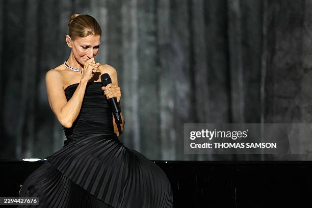 Canadian singer Celine Dion reacts as she performs during her first concert of a series at the Plenitude Arena in Nanterre, west of Paris on...