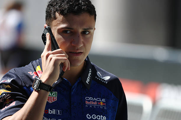 Isack Hadjar of France and Oracle Red Bull Racing talks on the phone as he walks in the Paddock during previews ahead of the F1 Grand Prix of Spain...