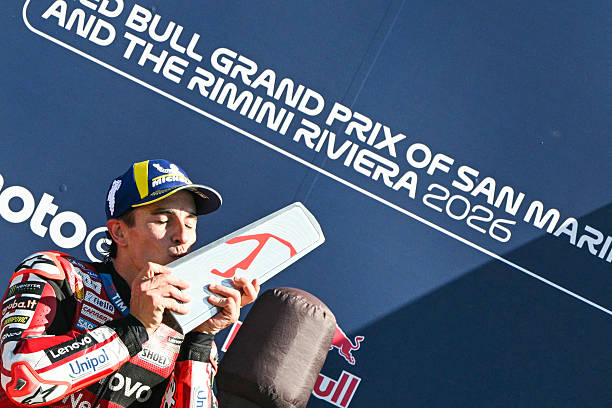 Ducati Lenovo Team's Spanish rider Marc Marquez kisses his trophy on the podium following his victory at the end of the San Marino Moto GP Grand Prix...
