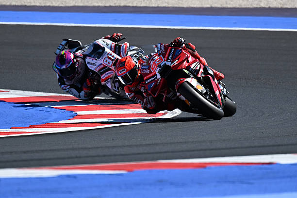 Marc Marquez of Spain, riding for Ducati Lenovo Team on a Ducati Desmosedici GP26, is followed by Jorge Martin of Spain, riding for Aprilia Racing on...