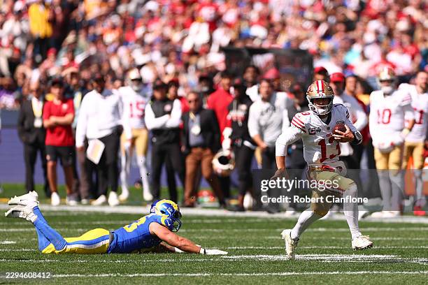 Brock Purdy of the San Francisco 49ers runs the ball in the third quarter of the NFL football game against Los Angeles Rams at the Melbourne Cricket...
