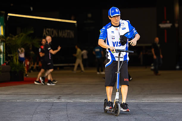 Yuki Tsunoda of Japan and Visa Cash App RB travels on a scooter in the paddock during practice ahead of the F1 Grand Prix of Spain at Madring on...