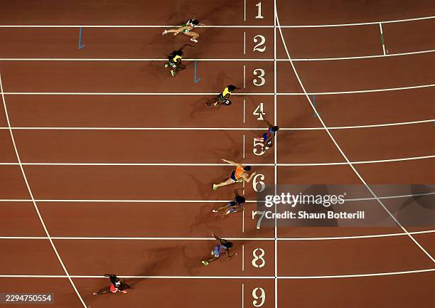 Masai Russell of Team United States crosses the finish line to win followed by Nadine Visser of Team Netherlands and Alaysha Johnson of Team United...