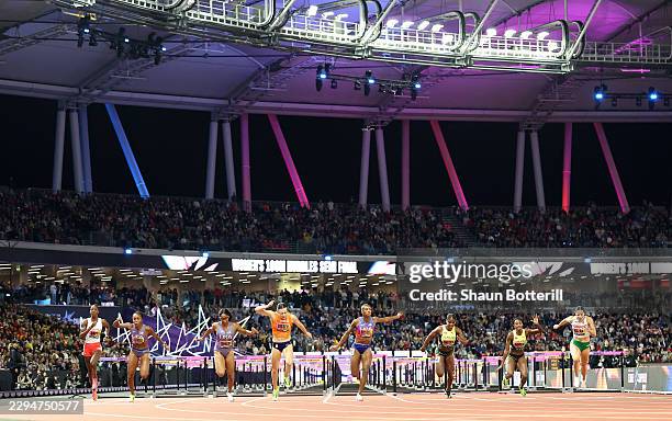 Masai Russell of Team United States crosses the finish line to win followed by Nadine Visser of Team Netherlands and Alaysha Johnson of Team United...
