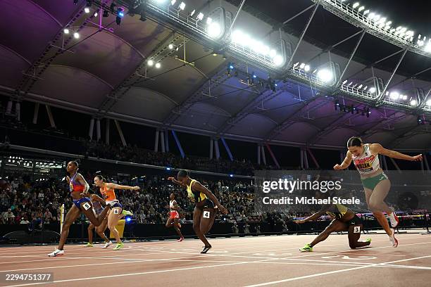 Masai Russell of Team United States crosses the finish line to win followed by Nadine Visser of Team Netherlands, Megan Simmonds of Team Jamaica and...