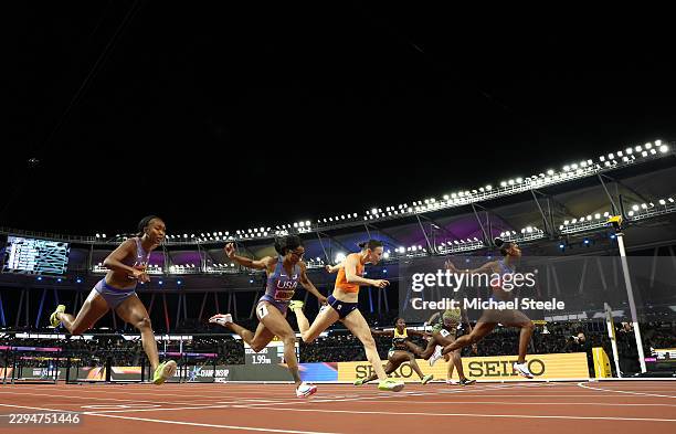 Masai Russell of Team United States crosses the finish line to win followed by Nadine Visser of Team Netherlands and Alaysha Johnson of Team United...