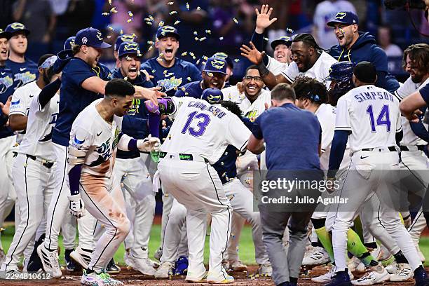 The Tampa Bay Rays celebrate as Junior Caminero scores after hitting a two-run home run to walk-off the Houston Astros at Tropicana Field on...
