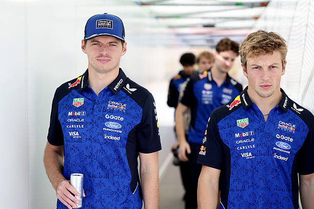 Max Verstappen of the Netherlands and Oracle Red Bull Racing and Liam Lawson of New Zealand and Oracle Red Bull Racing walk in the Paddock prior to...