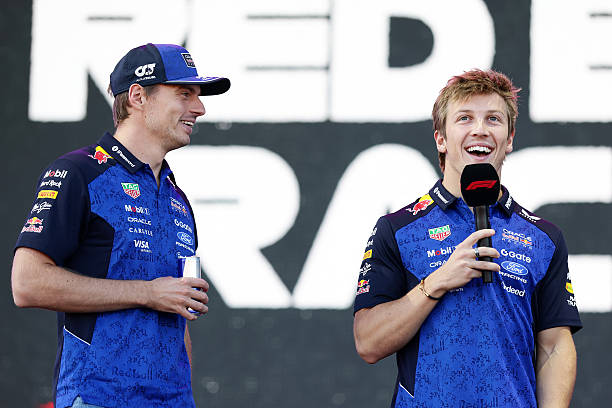 Max Verstappen of the Netherlands and Oracle Red Bull Racing and Liam Lawson of New Zealand and Oracle Red Bull Racing on stage prior to final...