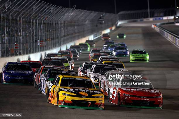 Carson Kvapil, driver of the Wilde Protein Crackers Chevrolet, and Jesse Love, driver of the Whelen Chevrolet, race during the NASCAR O'Reilly Auto...
