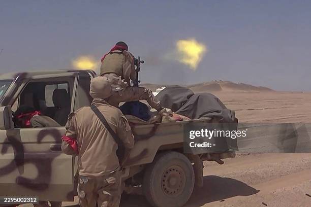 This frame grab taken from AFPTV video footage shows fighters affiliated with the Saudi-backed Yemeni government engaging in clashes with Houthi...