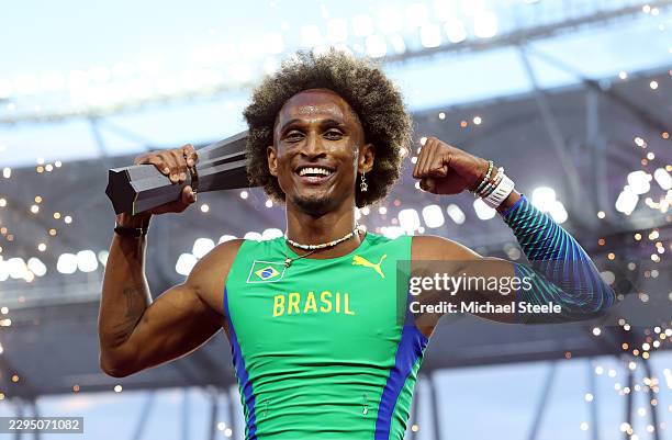 Winner, Alison Dos Santos of Team Brazil, poses for a photo on the podium with the winners' trophy after victory in the Men's 400 Metres Hurdles...