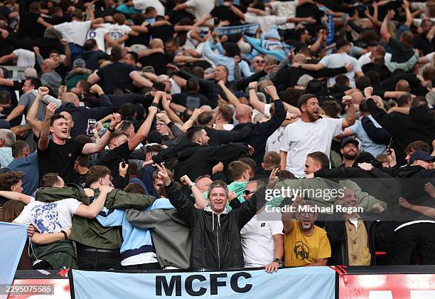 British musician Noel Gallagher of Oasis celebrates as the Manchester City behind him do 'The Poznan' after the Premier League 2026/27 match between...