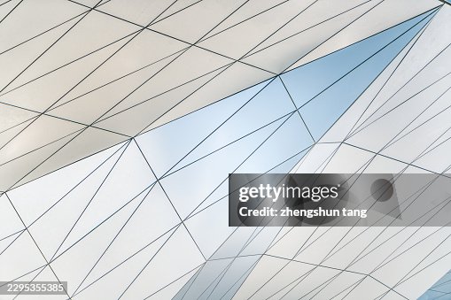 Triangular Facade Panels Reflecting Pale Blue Sky Triangular Facade Panels Reflecting Pale Blue Sky