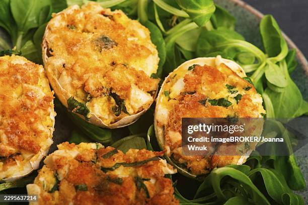 baked deviled eggs in shells with arugula on handmade ceramic plate - deviled eggs stock pictures, royalty-free photos & images