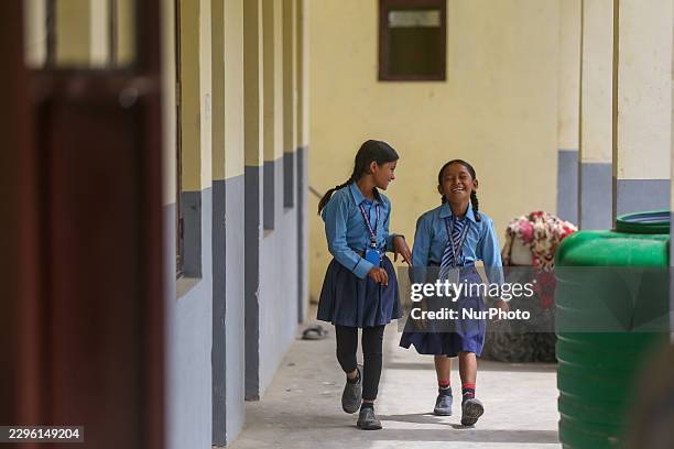 Students attend classes at a temporary under-construction facility of Shree Bageshwori Secondary School in Dhading, Nepal, on September 23 about four...