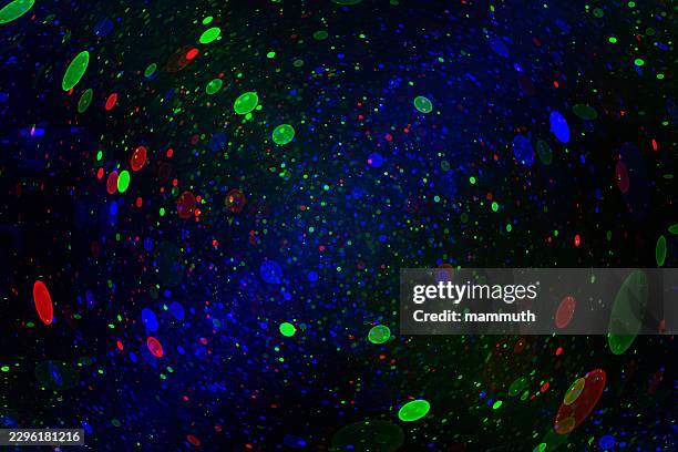 abstract glowing particles scattering, dark background, vibrant bokeh pattern, dynamic energy - string lights on black stock illustrations