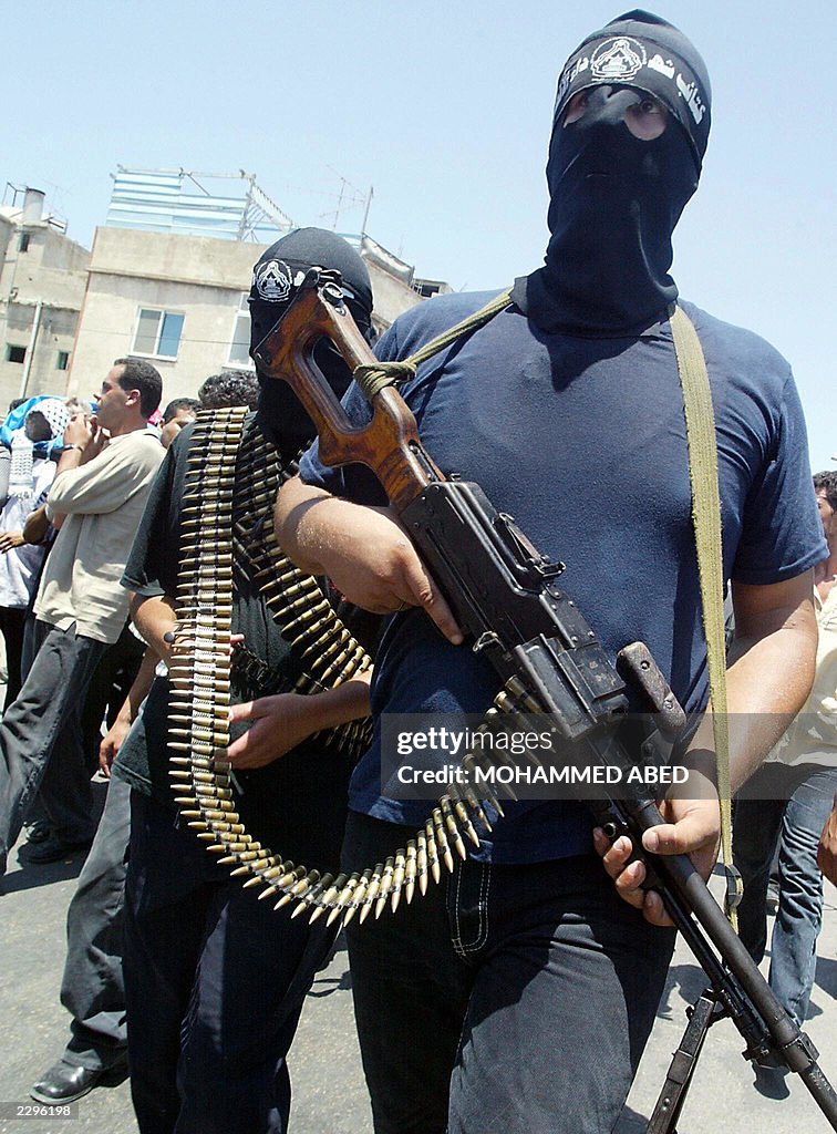 Masked armed members of the Al-Aqsa Brig