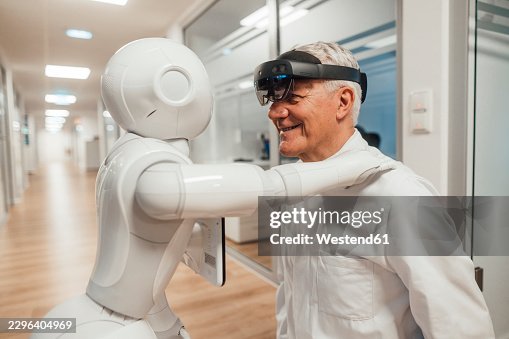 Scientist collaborates with humanoid robot using augmented reality in lab Scientist collaborates with humanoid robot using augmented reality in lab
