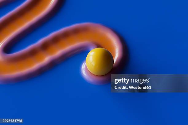 a yellow sphere rests on an orange fluid path over a blue background - different paths stock illustrations