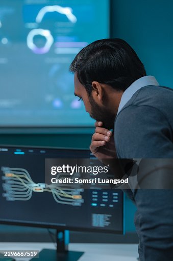 IT specialist analyzing computer screen during network system monitoring IT specialist analyzing computer screen during network system monitoring