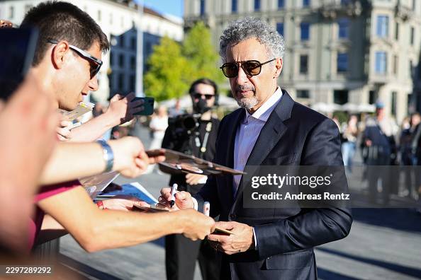 Signage Rug John Turturro signs autographs while arriving for the