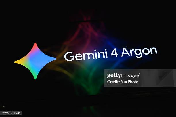 The Gemini 4 Argon logo is displayed on a smartphone screen resting on a reflective surface with a colorful abstract illustration projected onto it...