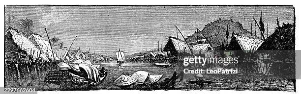 riverside village with thatched huts and boats on water - thatched roof stock illustrations