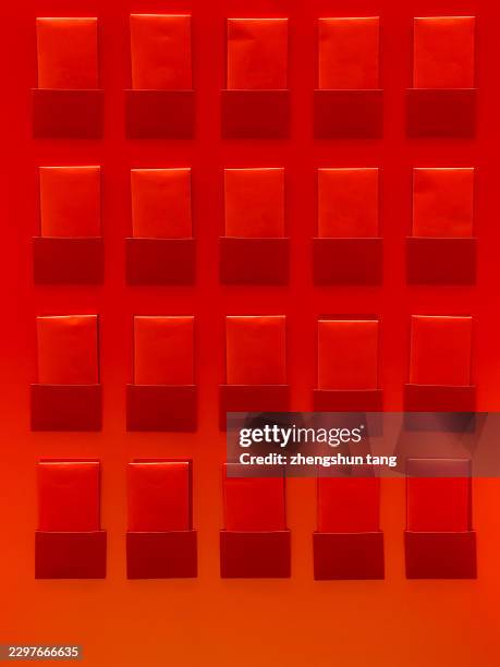 repeating red rectangular blocks on an orange wall - modular system stock pictures, royalty-free photos & images