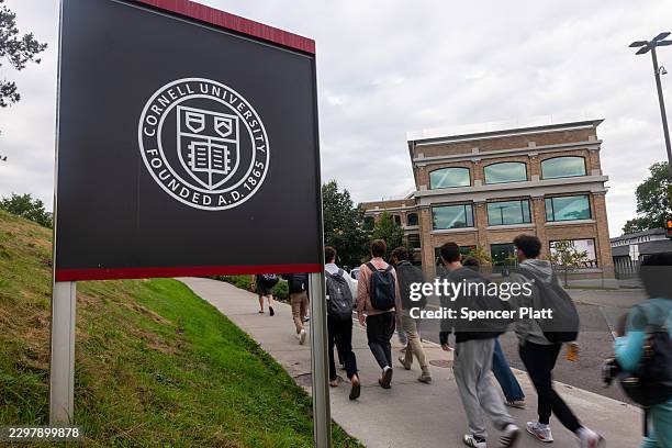 Students walk on the campus of Cornell University a day after on September 30 in Ithaca, New York. A New York state attorney general has announced a...
