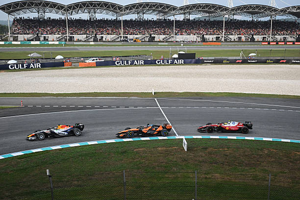 Racing Bulls' British driver Arvid Lindblad, McLaren's Australian driver Oscar Piastri and Ferrari's British driver Lewis Hamilton steer their cars...