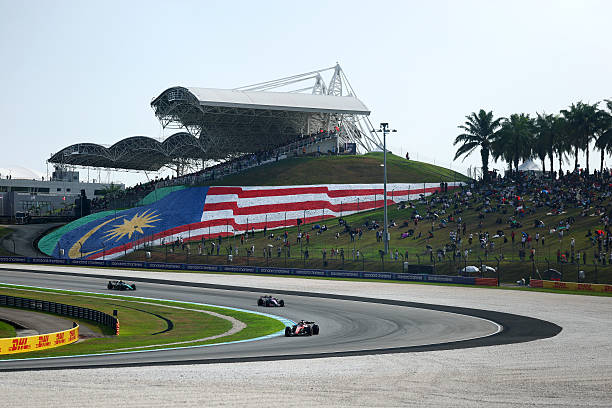Charles Leclerc of Monaco driving the Scuderia Ferrari SF-26 leads Franco Colapinto of Argentina driving the Alpine F1 A526 Mercedes and Andrea Kimi...