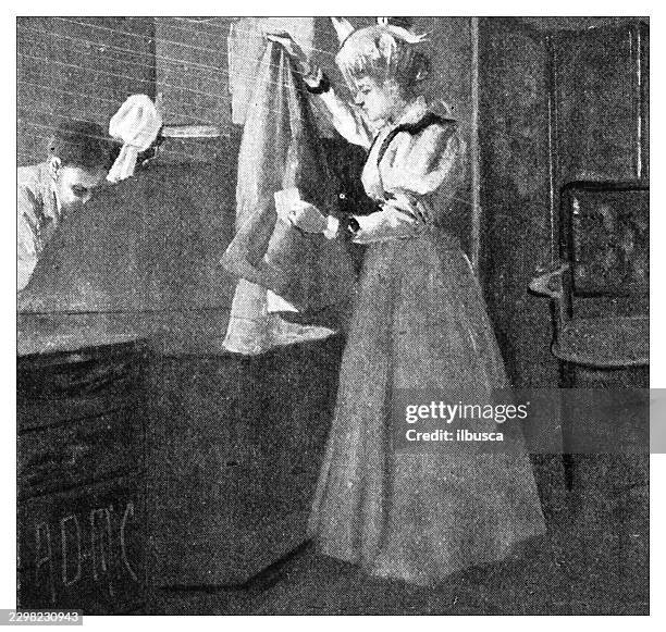 a lady handling clothes with a man in an indoor setting - two chairs on stage stock illustrations