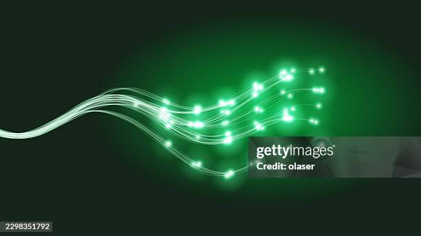 glowing green light trails curve across a dark background, with bright spark-like points clustering toward the right and fading into soft luminous motion. - green screen background stock illustrations