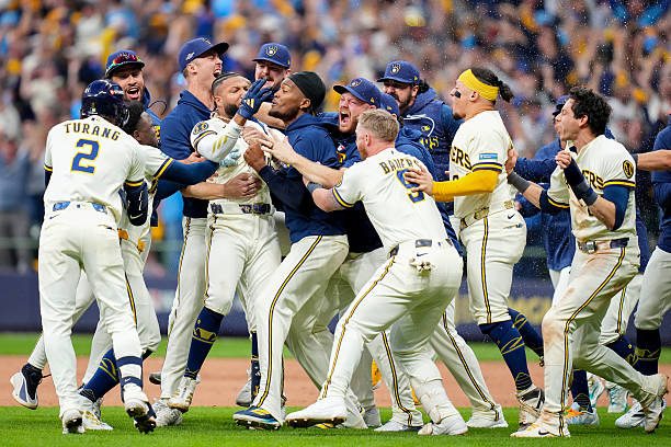 Jackson Chourio of the Milwaukee Brewers is congratulated by his teammates after hitting the game-winning two-run single against the San Diego Padres...