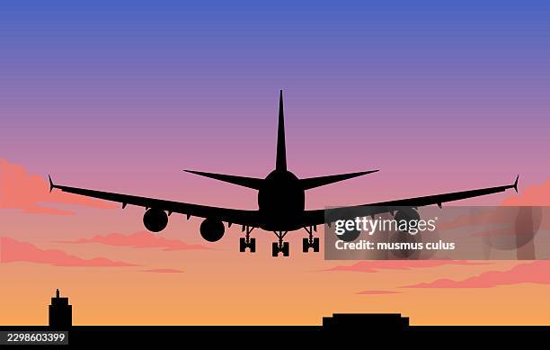airplane silhouette flying over city at sunset - sun above clouds stock illustrations