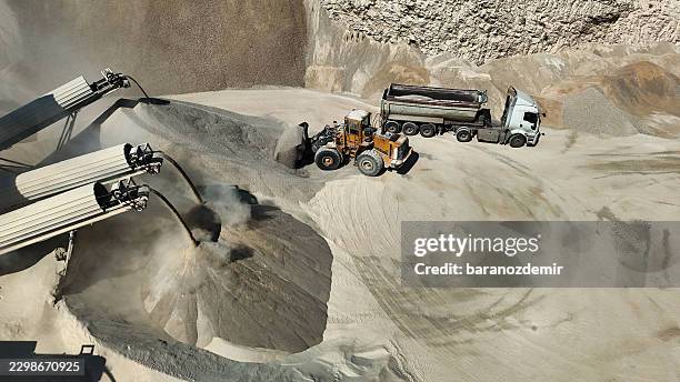wheel loader and dump truck at aggregate processing plant - aggregate transport stock pictures, royalty-free photos & images