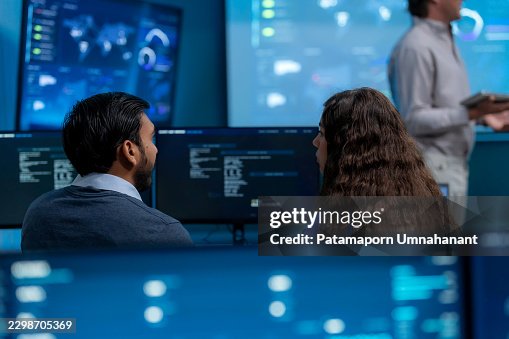 Software Developers Writing Code and Planning Cloud System Infrastructure for AI Technology at Workstation in Control Room Software Developers Writing Code and Planning Cloud System Infrastructure for AI Technology at Workstation in Control Room