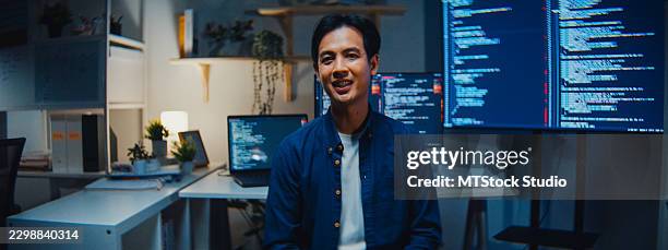 young asian male data scientist explains a computer language on a web conference working at night in the office. artificial intelligence data science, python programming, network security concepts. - javascript stock pictures, royalty-free photos & images