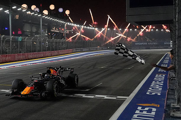 Red Bull Racing's Dutch driver Max Verstappen crosses the chequered flag at the finish line to win the Formula One Singapore Grand Prix at the Marina...