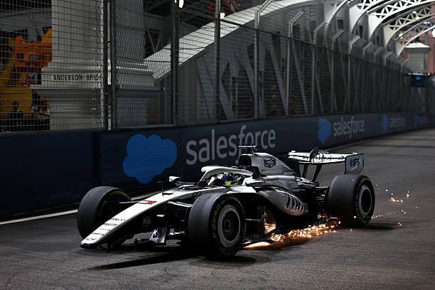 Sergio Perez of Mexico driving the Cadillac F1 Team MAC-26 Ferrari heads to the pitlane with damage after a crash during Sprint Qualifying ahead of...