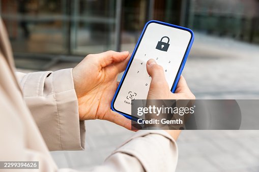 Person unlocking smartphone using passcode for data security Person unlocking smartphone using passcode for data security