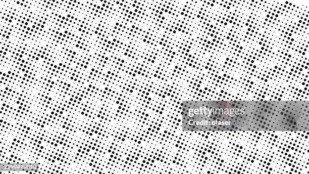 black halftone dots scattered across a white background in a diagonal pattern, creating a dense monochrome texture with a retro print feel. - offset printing stock illustrations