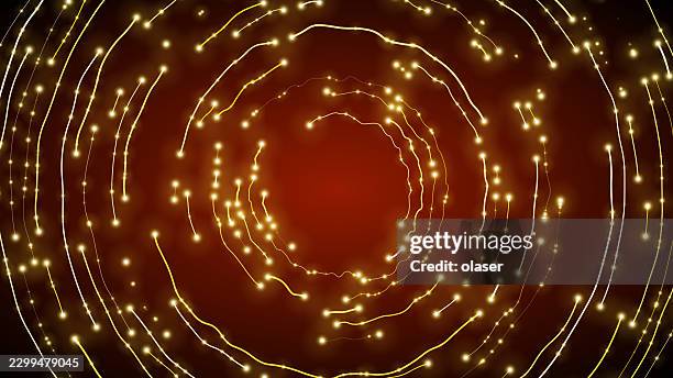 glowing golden light trails form concentric circular rings around a warm red center on a dark background, creating a bright swirling pattern with scattered sparkling points. - light painting stock illustrations