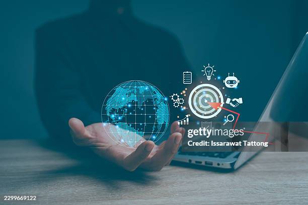 business professional using a computer with a virtual global interface and target icon, representing digital marketing strategy, online advertising, seo optimization, - digital campaign stock pictures, royalty-free photos & images