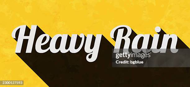 heavy rain - text with long shadow on textured yellow background - heavy rainfall stock illustrations