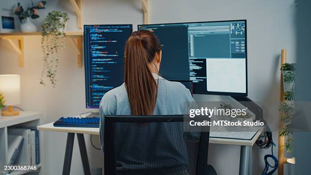 asian female computer programmer uses a digital tablet to check coding while working in home office. software development, digital transformation, tech expertise, artificial intelligence concept. - application programming interface stock pictures, royalty-free photos & images