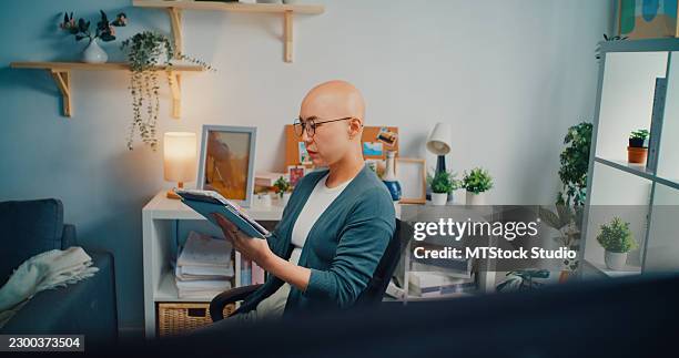young asian female programmer cancer patient analyzing binary code on digital tablet and computer in home office. software development, blockchain, network security, artificial intelligence concept. - javascript stock pictures, royalty-free photos & images