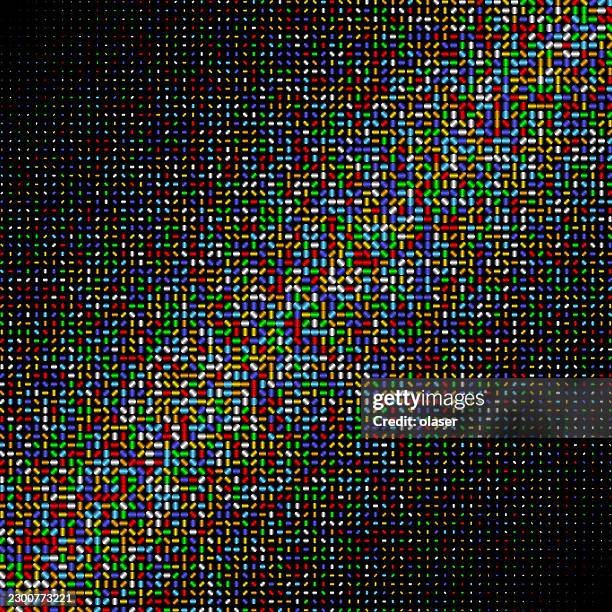 a dense field of tiny multicolored pixels forms a bright diagonal band across a dark background, creating a vivid mosaic-like pattern with scattered light. - soft light stock illustrations